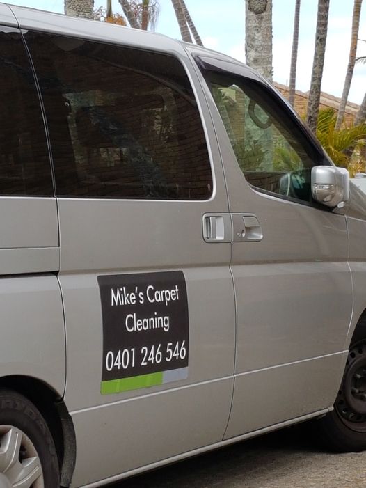 Mike’s silver van with a sign on the door reading Mike’s Carpet Cleaning 0401 246 546